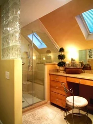 Bathroom design in the attic with a sloping ceiling