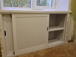 Cabinet In The Window Sill In The Kitchen Photo