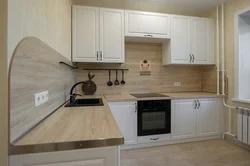 Photo of a kitchen with an apron and a wood-look countertop