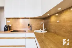 Photo of a kitchen with an apron and a wood-look countertop
