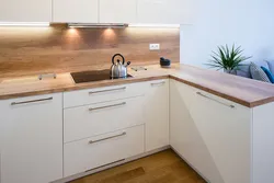 Photo of a kitchen with an apron and a wood-look countertop