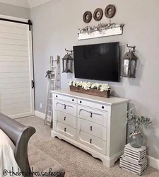 TV on the chest of drawers in the bedroom interior