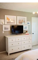 TV on the chest of drawers in the bedroom interior
