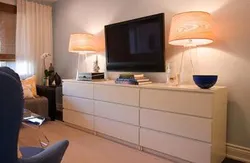 TV on the chest of drawers in the bedroom interior
