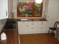 Kitchen set by the window photo in the apartment