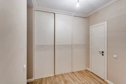 Built-in wardrobe along the entire wall in the hallway photo