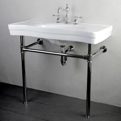 Photo of a bathtub with a sink and a bedside table in the bathroom