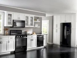 Photo of a kitchen with a black refrigerator photo