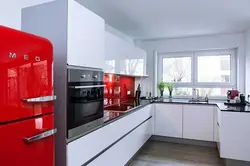 Қызыл тоңазытқышы бар ас үй интерьерінің фотосуреті