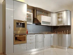 Photos of corner kitchens with built-in appliances and counter