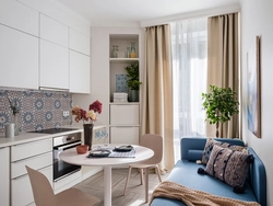 Interior of a rectangular kitchen with a sofa photo