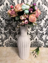 Floor vase with flowers in the interior of the living room