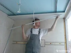 Step-by-step photo of a bathroom ceiling made of plastic panels