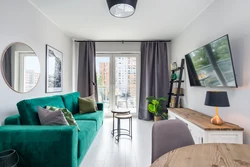 Emerald sofa in the interior of the kitchen living room