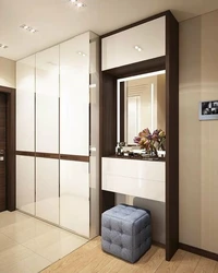 Design of a narrow hallway with a wardrobe in a modern style