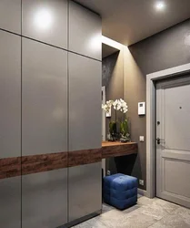 Design of a narrow hallway with a wardrobe in a modern style