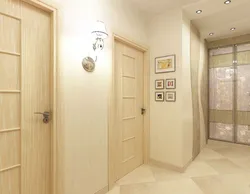 Light wallpaper in the hallway under light doors photo