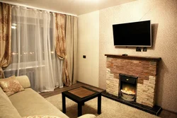 Interior of a living room with a fireplace in an apartment of 18 sq m
