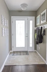 Tiles at the entrance door in the hallway and laminate photo