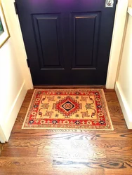 Tiles at the entrance door in the hallway and laminate photo