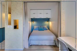 Interior of a room in a one-room apartment with a bed photo