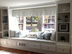 Cabinets by the window in the living room interior