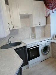 Kitchen design in Khrushchev with a gas water heater and a washing refrigerator