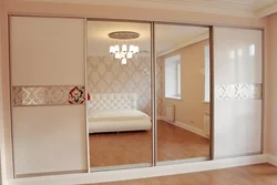 Photo of a wardrobe in the bedroom with a mirror for three doors