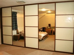 Photo of a wardrobe in the bedroom with a mirror for three doors