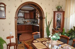 Kitchen with an arch to the living room in the apartment photo