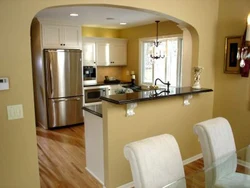 Kitchen with an arch to the living room in the apartment photo