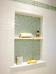 Niche in the bathroom for shampoos made of tiles photo