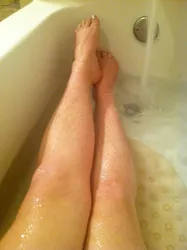 Photo of women's legs in the bathroom