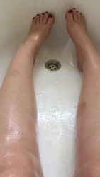 Photo of women's legs in the bathroom