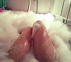 Photo of women's legs in the bathroom