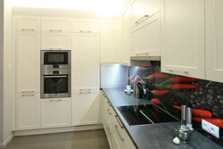 Kitchen design along one wall with a refrigerator photo