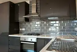 Kitchens with black tiles on the wall photo
