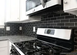 Kitchens with black tiles on the wall photo