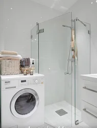 Bathroom design photo with shower, washing machine, toilet