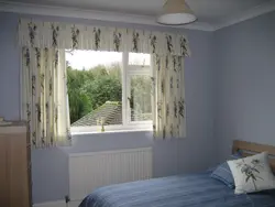 Curtains up to the window sill in the living room in a modern interior