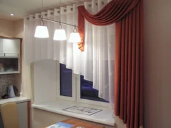 Curtains up to the window sill in the living room in a modern interior