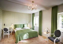 Green color of curtains in the bedroom interior
