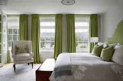 Green color of curtains in the bedroom interior