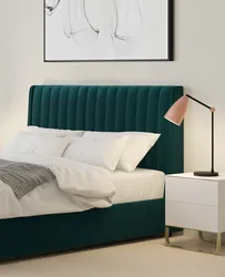 Turquoise bed in a bedroom interior with soft