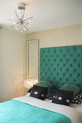 Turquoise bed in a bedroom interior with soft