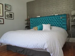 Turquoise bed in a bedroom interior with soft