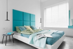 Turquoise bed in a bedroom interior with soft
