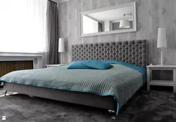 Turquoise bed in a bedroom interior with soft