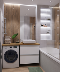Interior of a bathroom with a bathtub without a toilet with a washing machine
