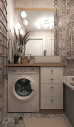 Interior of a bathroom with a bathtub without a toilet with a washing machine